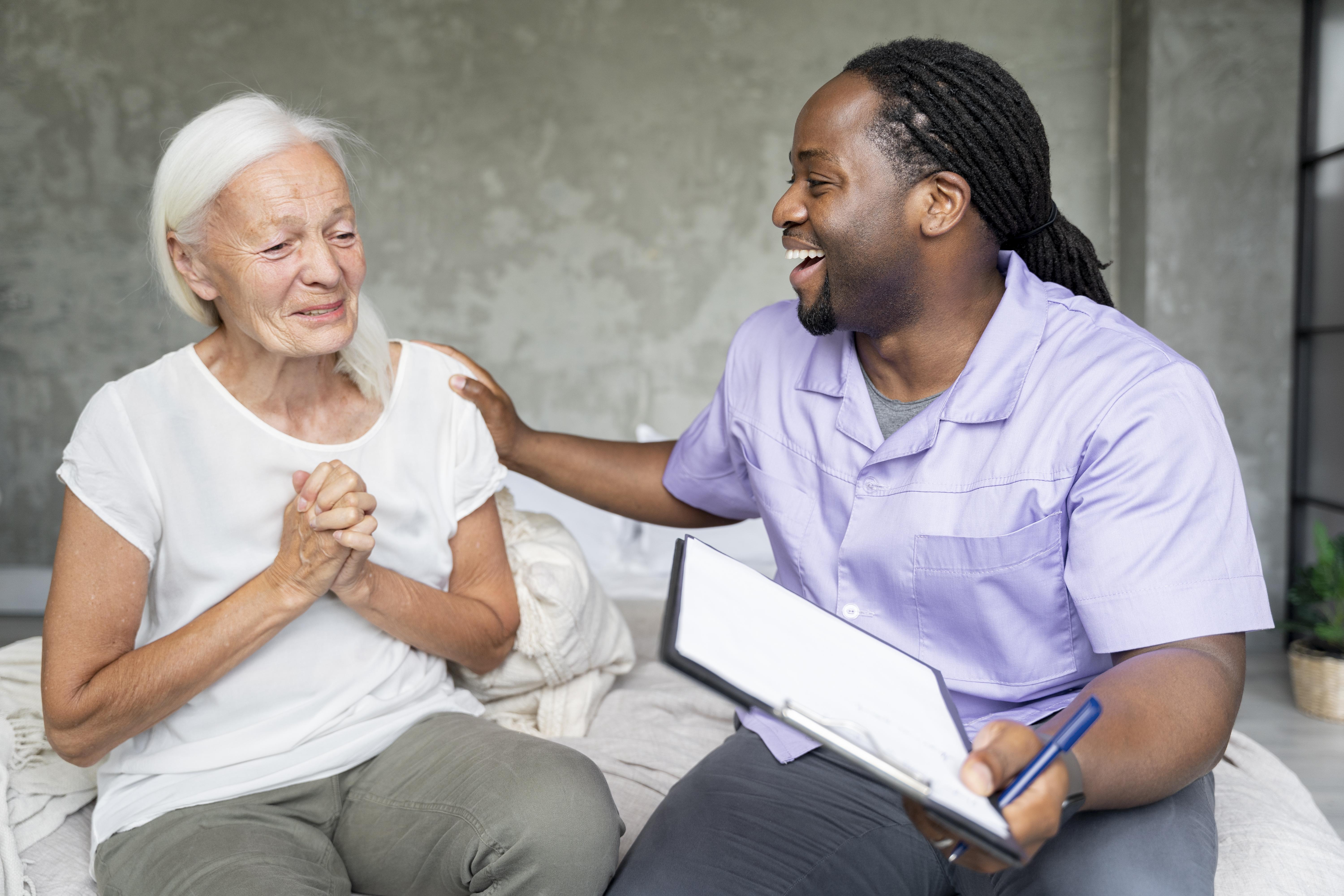 Social worker taking care of an old woman